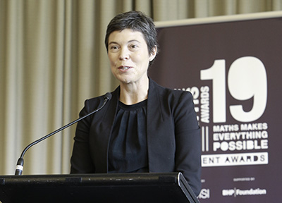 Photo of Louise Puslednik giving an acceptance speech at the 2019 ChooseMATHS Awards dinner